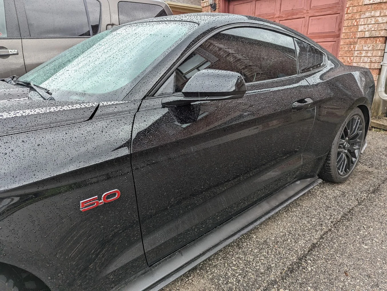 Mustang with tinted windows and beaded rain